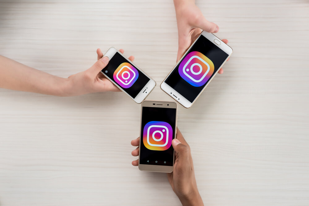 Three people opening the Instagram app on their phone