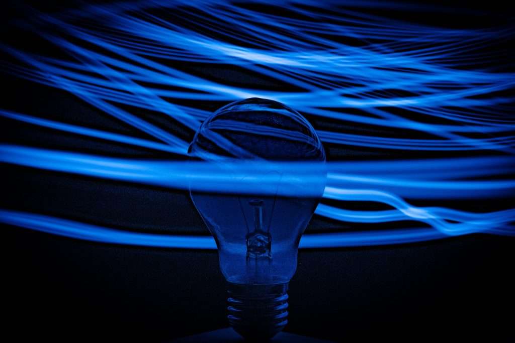 A blue backlit background with an unlit lightbulb