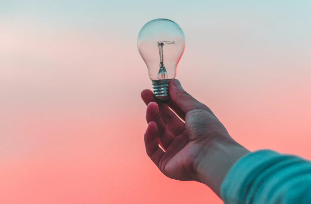 Light bulb in front of a beautiful sunset