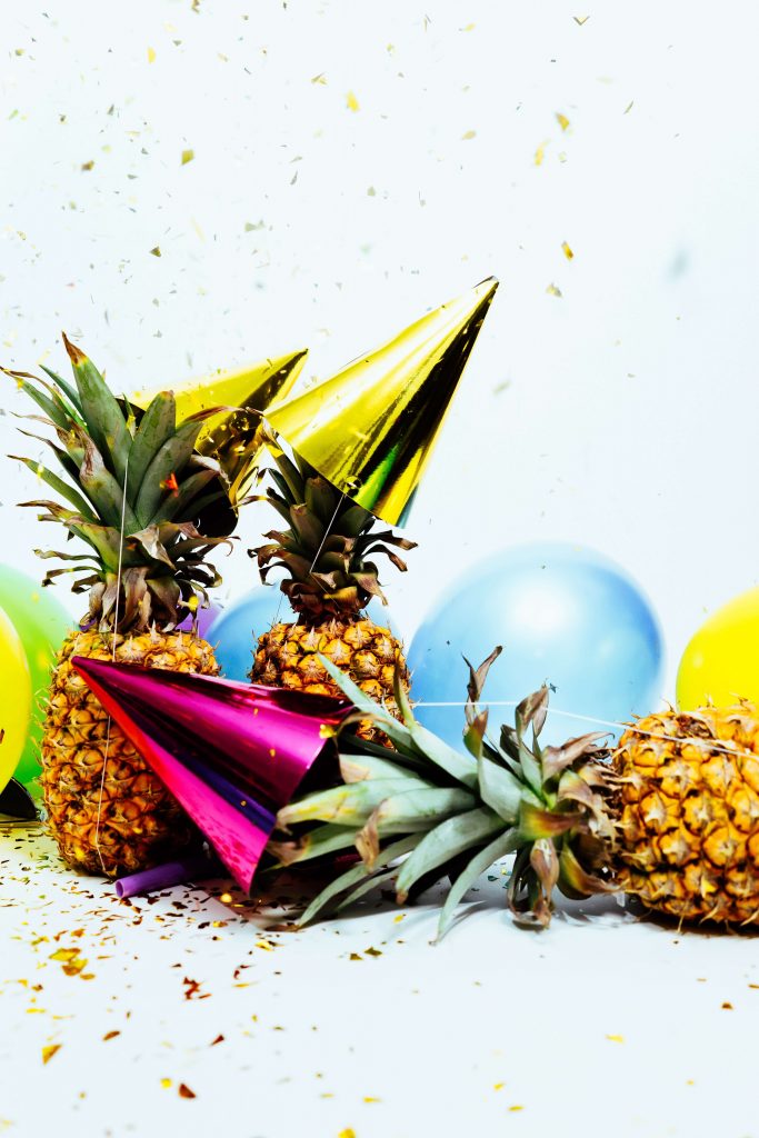 Pineapples, party hats, balloons, and confetti