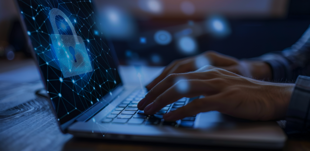 A person's hands typing on a computer with a pixelated lock symbol and scatter plot points on the computer screen to signify third party cookies