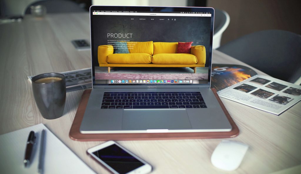 An open laptop on a cluttered table