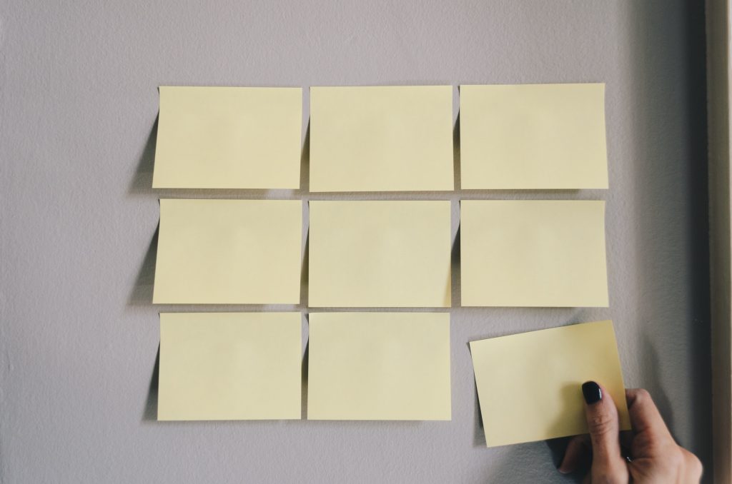 Yellow Post-it notes attached to a grey wall