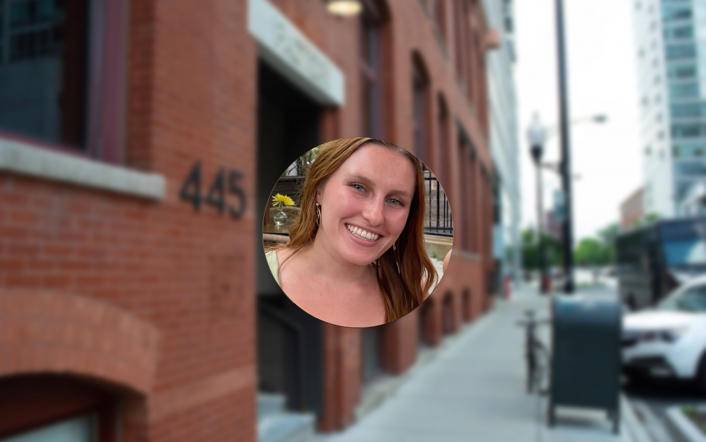 Circular photo of Kelsey Connolly with the background as the exterior of Logical's brick office building