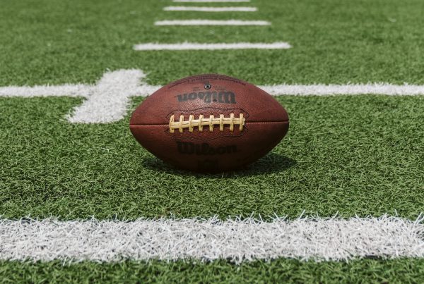 A football in the center of a football field