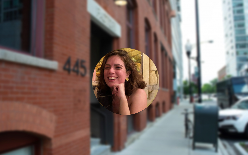 Circular photo of Marta Vucci with the background as the exterior of Logical's brick office building
